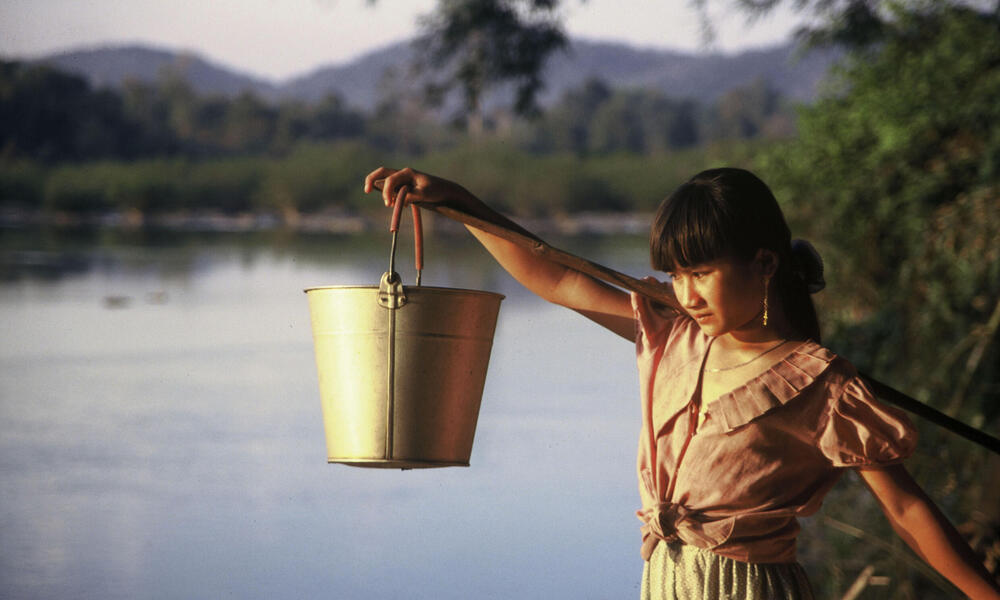 Tribal girl collects water in the evening from the Serepok River in a poor commune in Vietnam's Central Highlands where thousands of poor villagers have access to sanitation