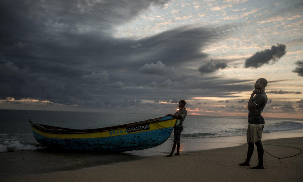 Two men with their boat on the beach in Mozambique