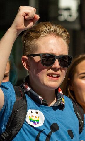 Blonde hair man with sunglasses and fist up at a march