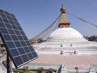 Solar panel on a roof top over looking a Buddhist shrine, Bodhnath Stupa in Kathmandu, Nepal