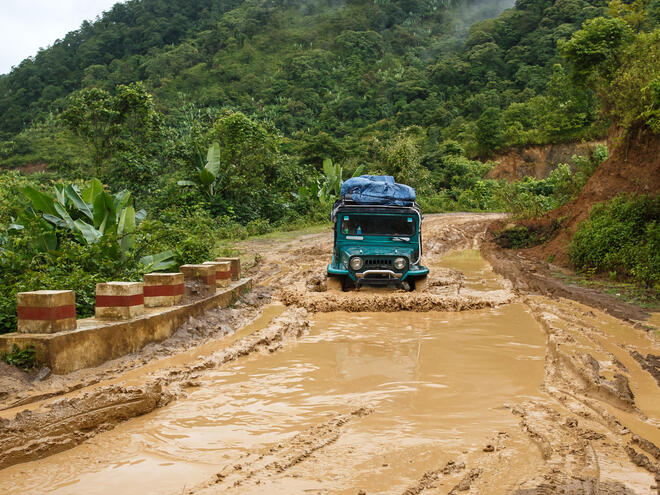 A truck drives through a flooded road in Myanmar.