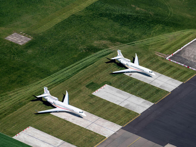 Aerial view of 2 private jets, Dassault Falcon, at The Hague Rotterdam Airport.