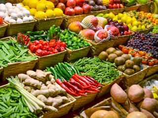Large display of several rows of fruits and vegetables 