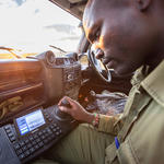 Ranger Lema Lankas tests the control board to pan and tilt the mobile FLIR camera mounted on top of the truck. The camera can focus on objects (like poachers) nearly a mile away.
